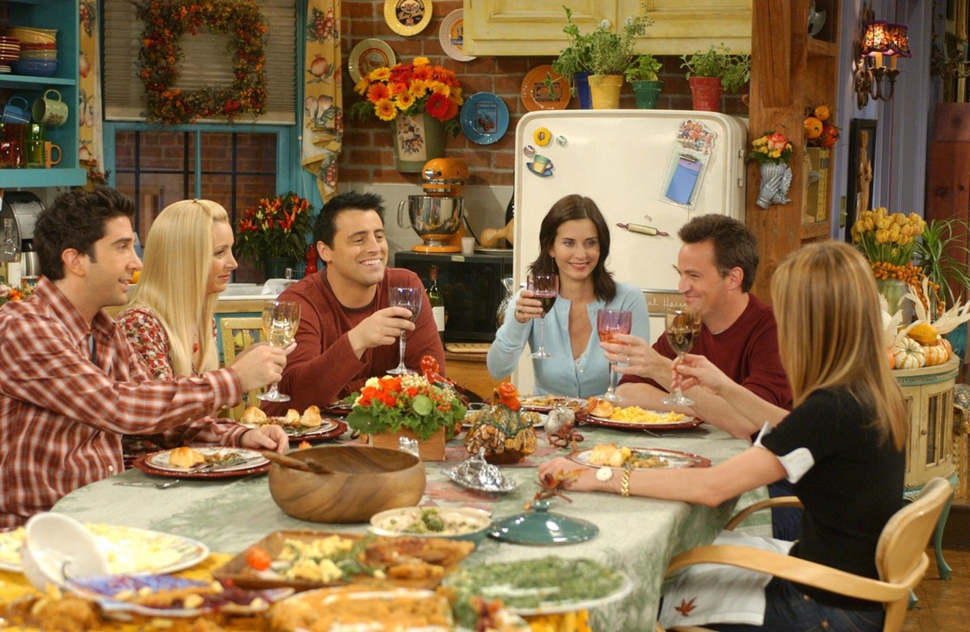 Los personajes de la serie Friends reunidos alrededor de una mesa con comida para el Día de Acción de Gracias